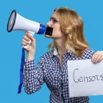 young-blonde-woman-holding-megaphone-and-banner-with-censorship-inscription