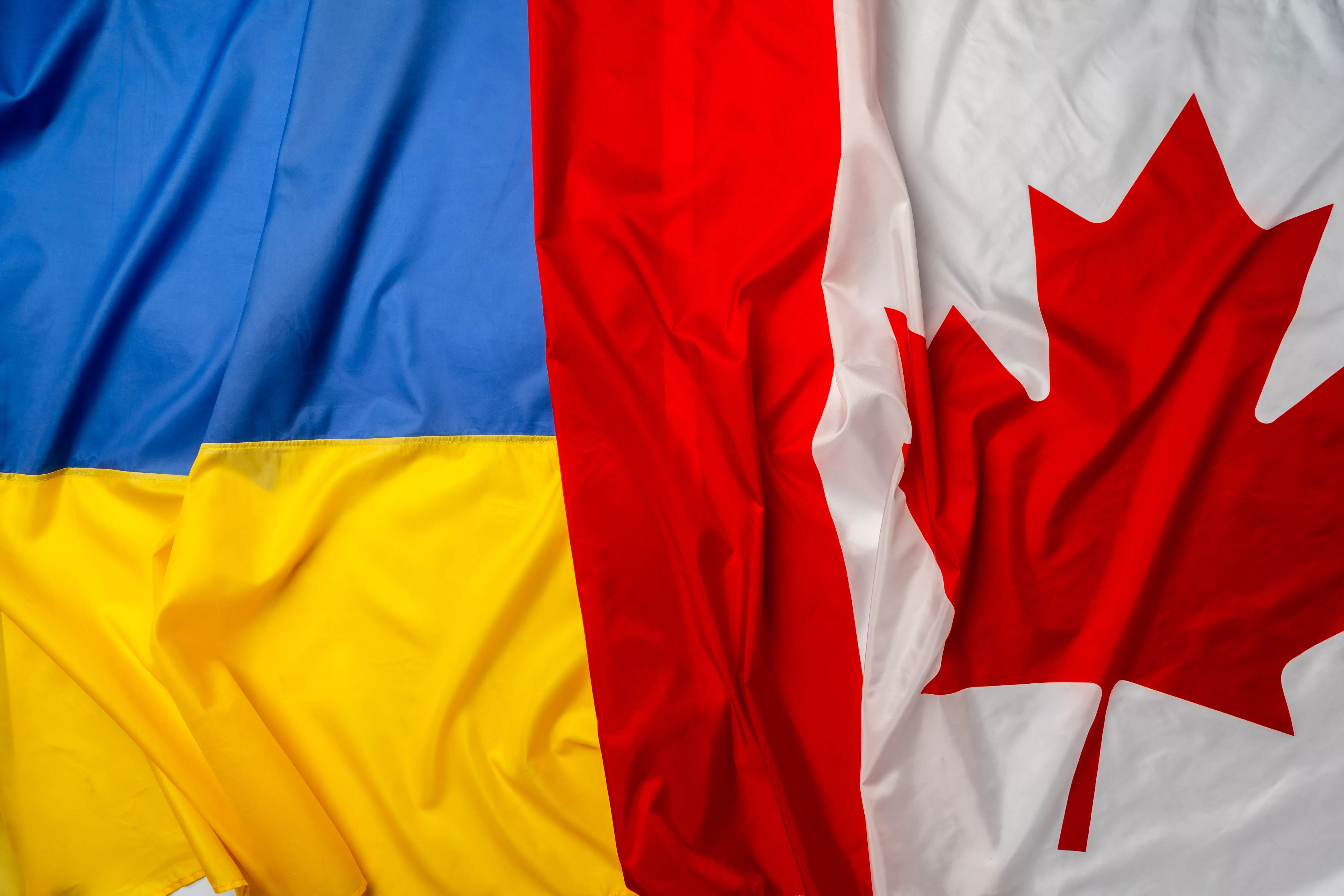 flags-of-ukraine-and-canada-folded-together