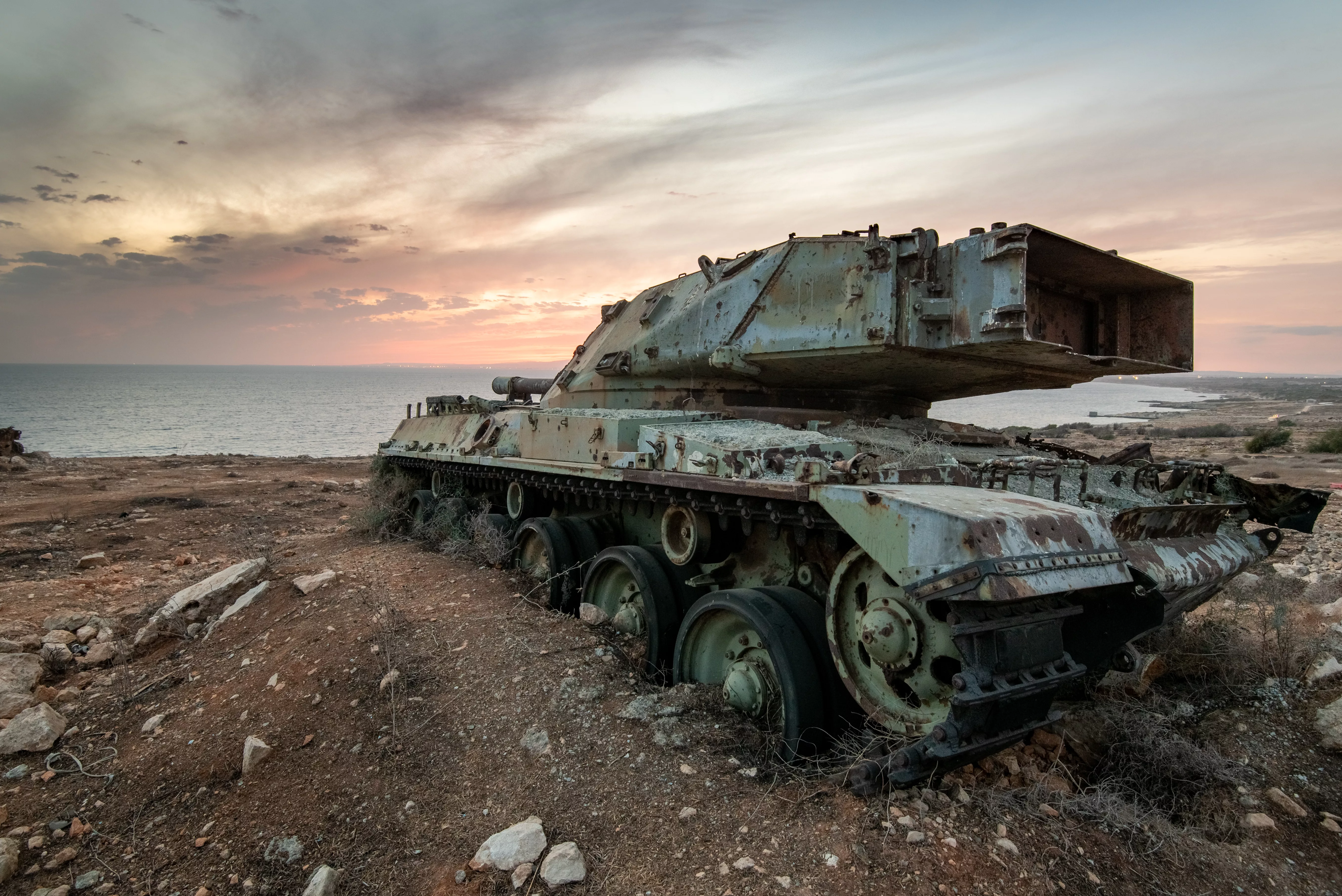 abandoned-military-army-tank-vehicle-at-sunse-scrap-metal-environmental-pollution