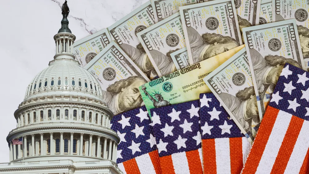 financial-a-stimulus-bill-individual-checks-from-government-us-100-dollar-bills-currency-american-flag-global-pandemic-covid-19-lockdown