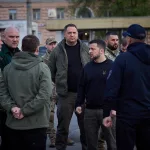 Vladimir Zelenskyy speaks with first responders on a street in Ukraine / Wikimedia Commons