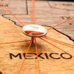 mexico-flag-on-the-pushpin-and-red-threads-on-the-wooden-map