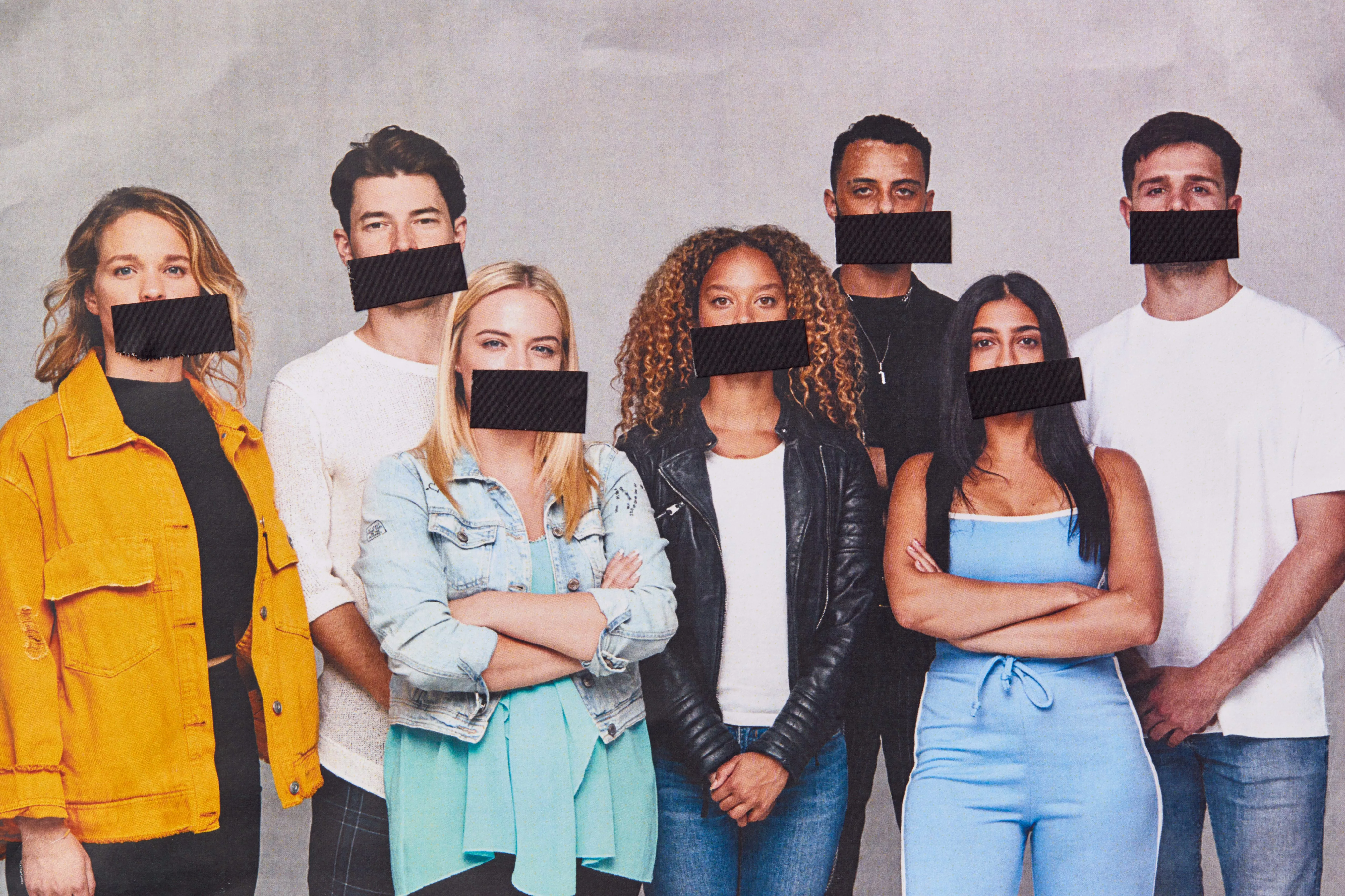 young adults with tape over their mouths