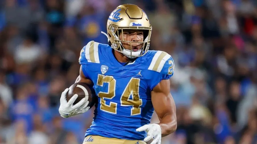 UCLA running back Zach Charbonnet (24) escapes a tackle-attempt by Washington linebacker Alphonzo Tuputala (11) during an NCAA college football game Friday^ Sept. 30^ 2022^ in Pasadena^ Calif.