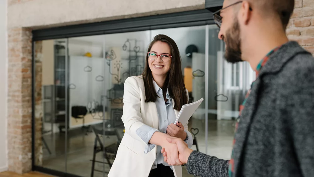 Interviewee shaking hand of interviewer.