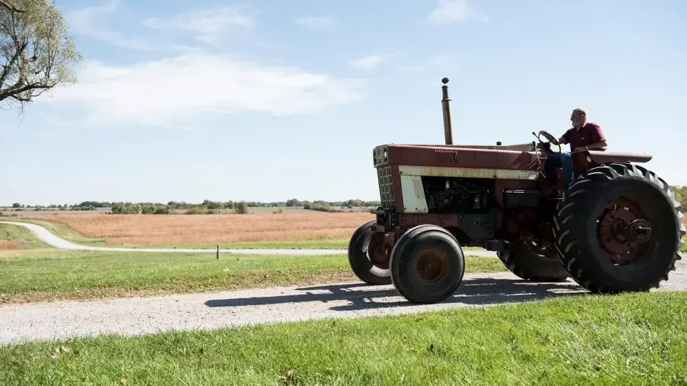 farmer-driving-tractor-on-rural-road-missouri-us-2026-03-10-02-06-30-utc-jpg