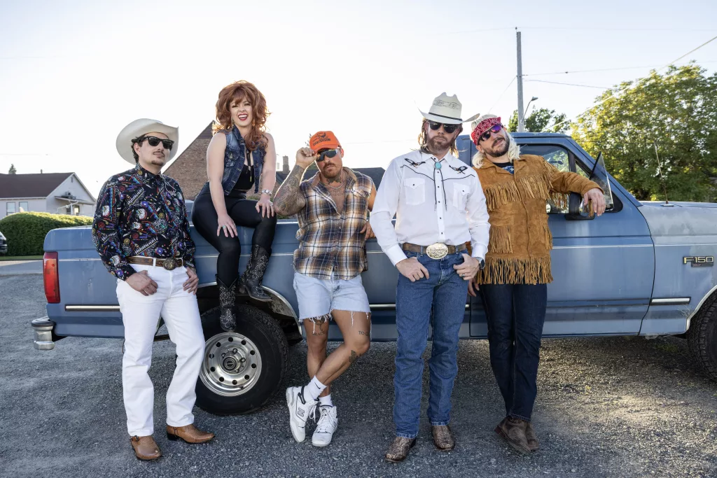 The Chattahoochees band in front of a pickup truck