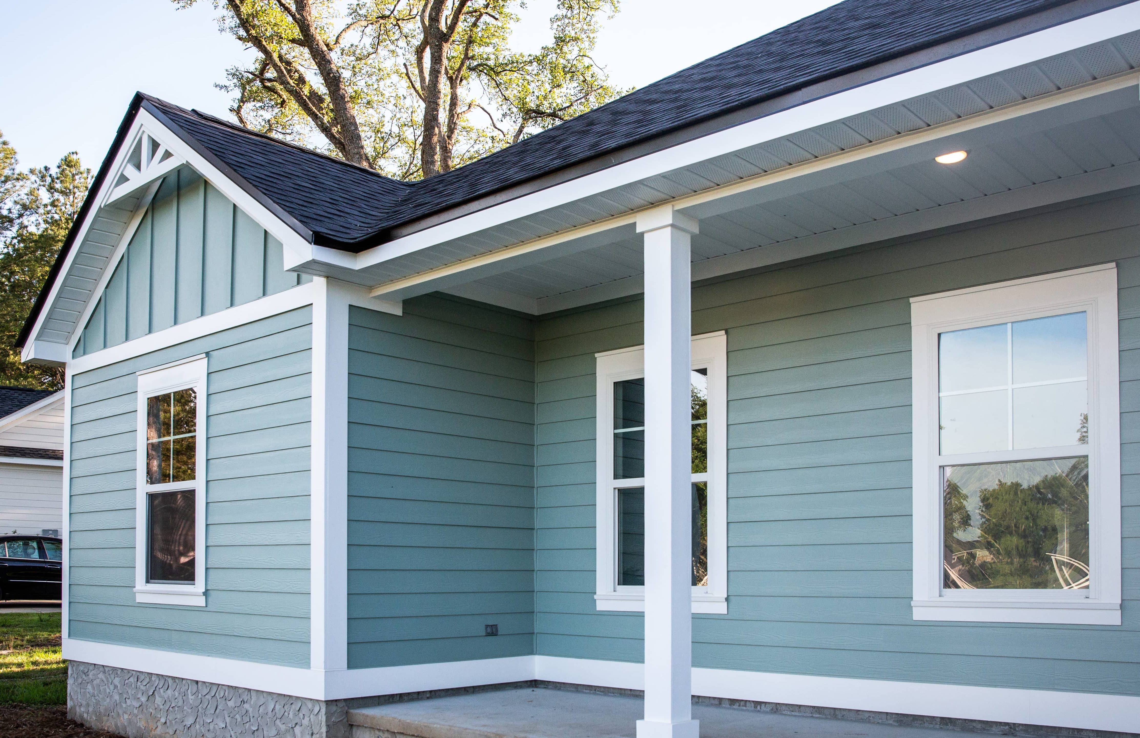 front-view-of-a-brand-new-construction-house-with-blue-siding-a