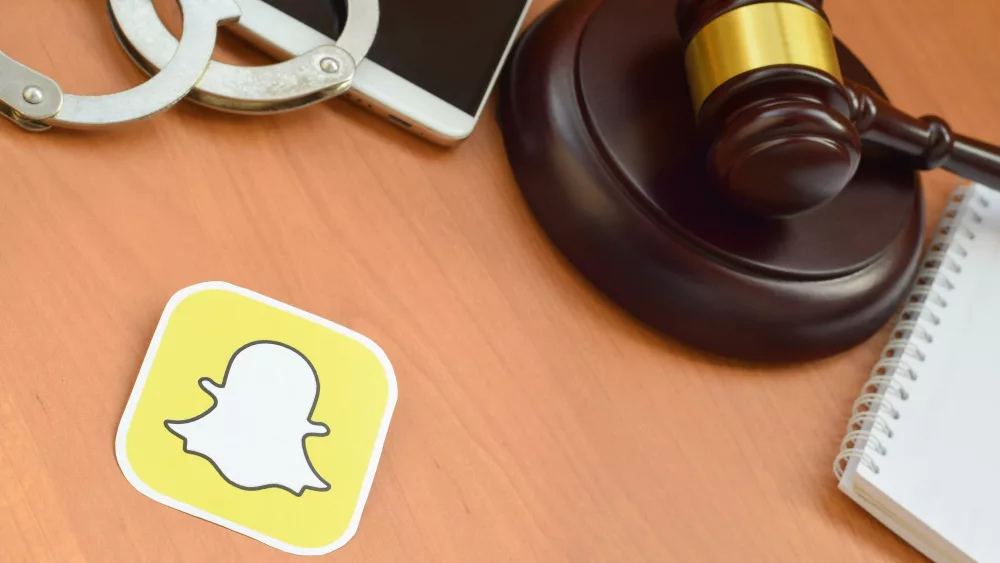 snapchat-paper-logo-lies-with-wooden-judge-gavel-smartphone-and-handcuffs-entertainment-