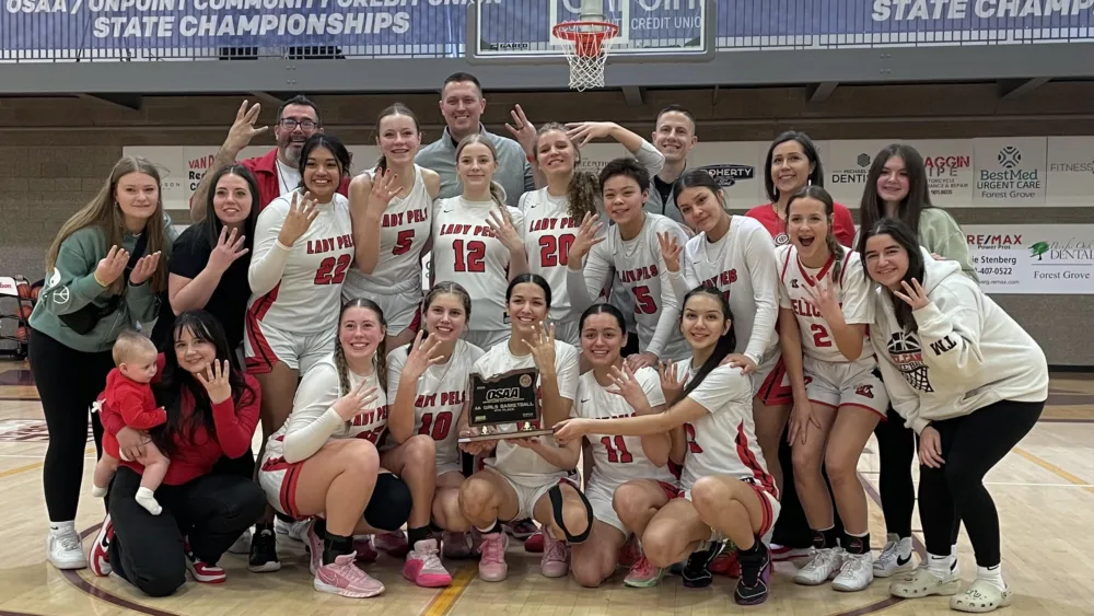 The Klamath Union girls basketball team with the fourth place trophy