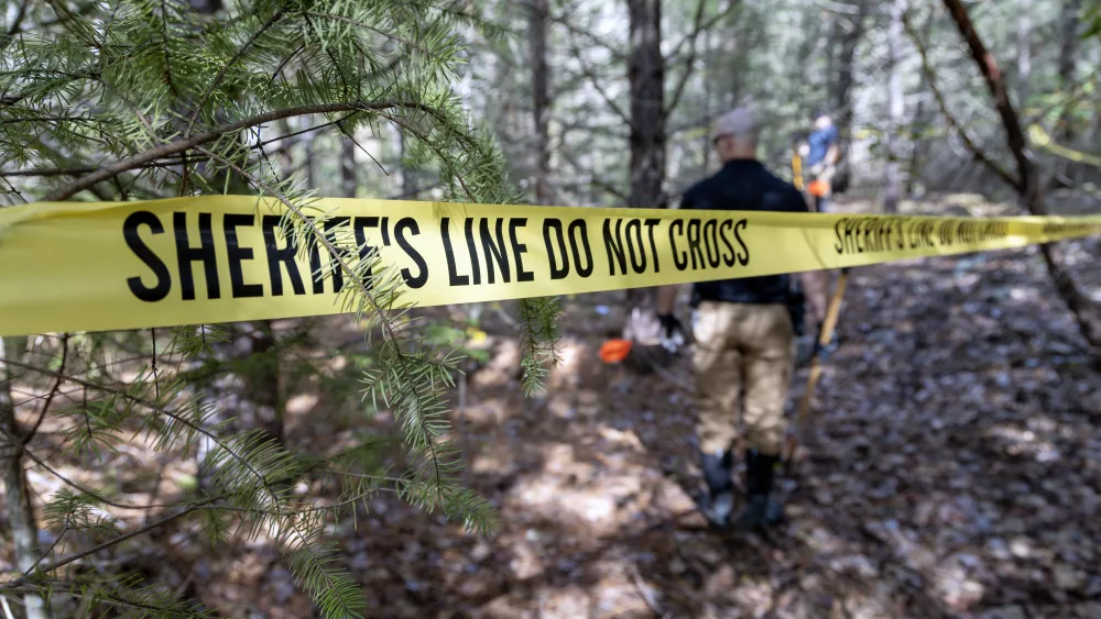 A taped off crime scene in the woods