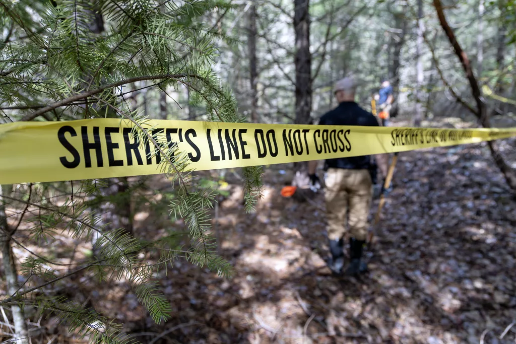 A taped off crime scene in the woods