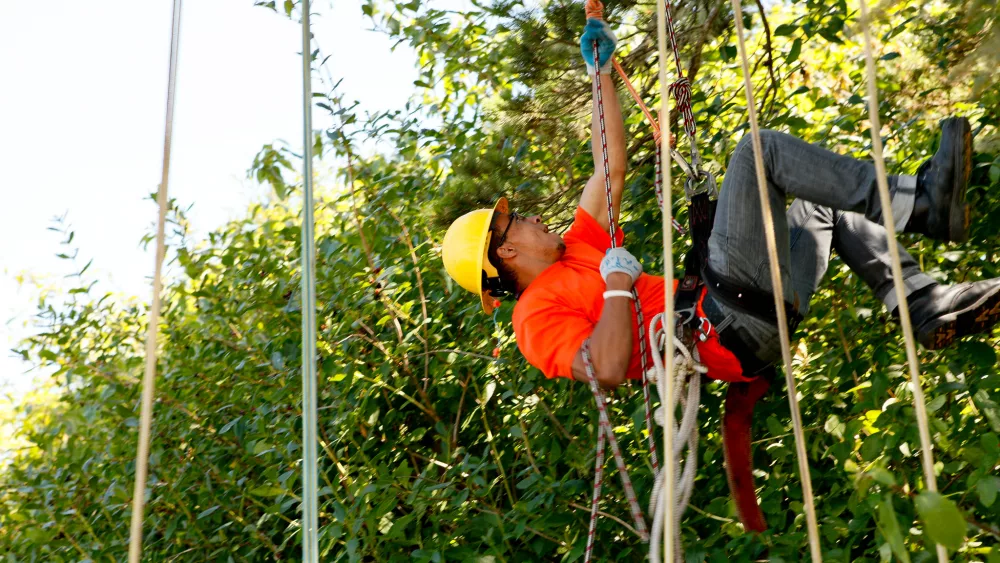 An urban forestry student descends a rope during an Angell Job Corps Open House on the Siuslaw National Forest in 2011