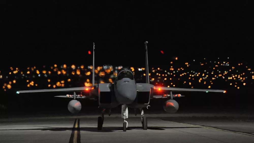 An F-15 on the ground at night