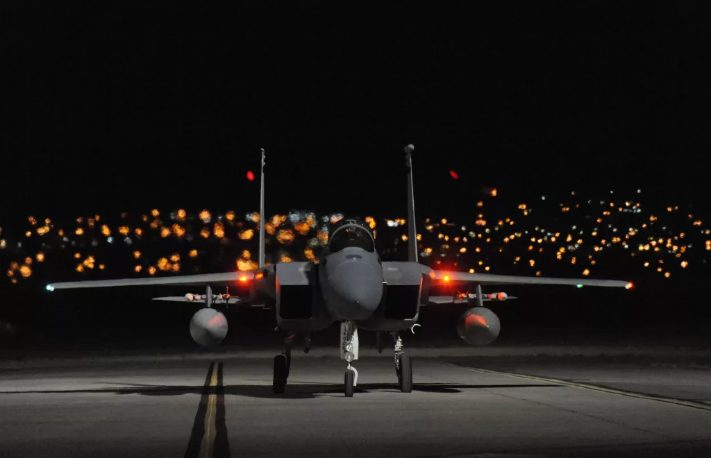 An F-15 on the ground at night