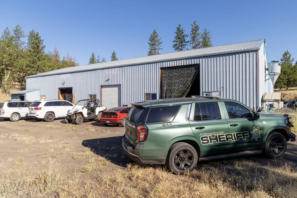 A JCSO car outside the black market marijuana grow in Shady Cove