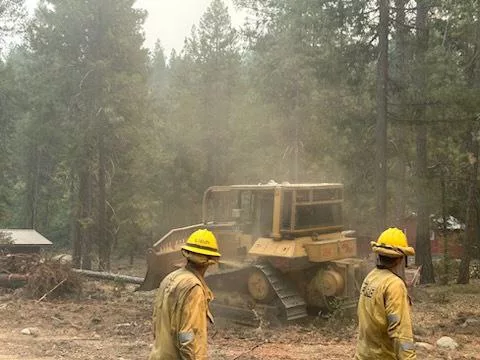 Firefighters and a bulldozer working on the Shelly Fire