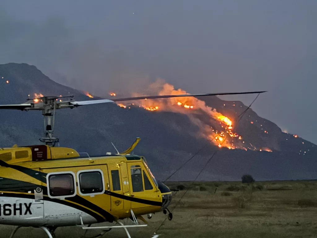 A helicopter on the ground near the Warner Peak Fire