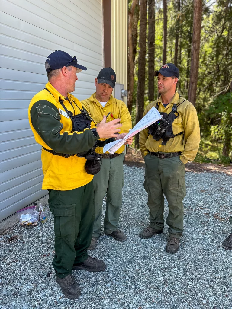 Firefighters on the Dixon Fire go over information