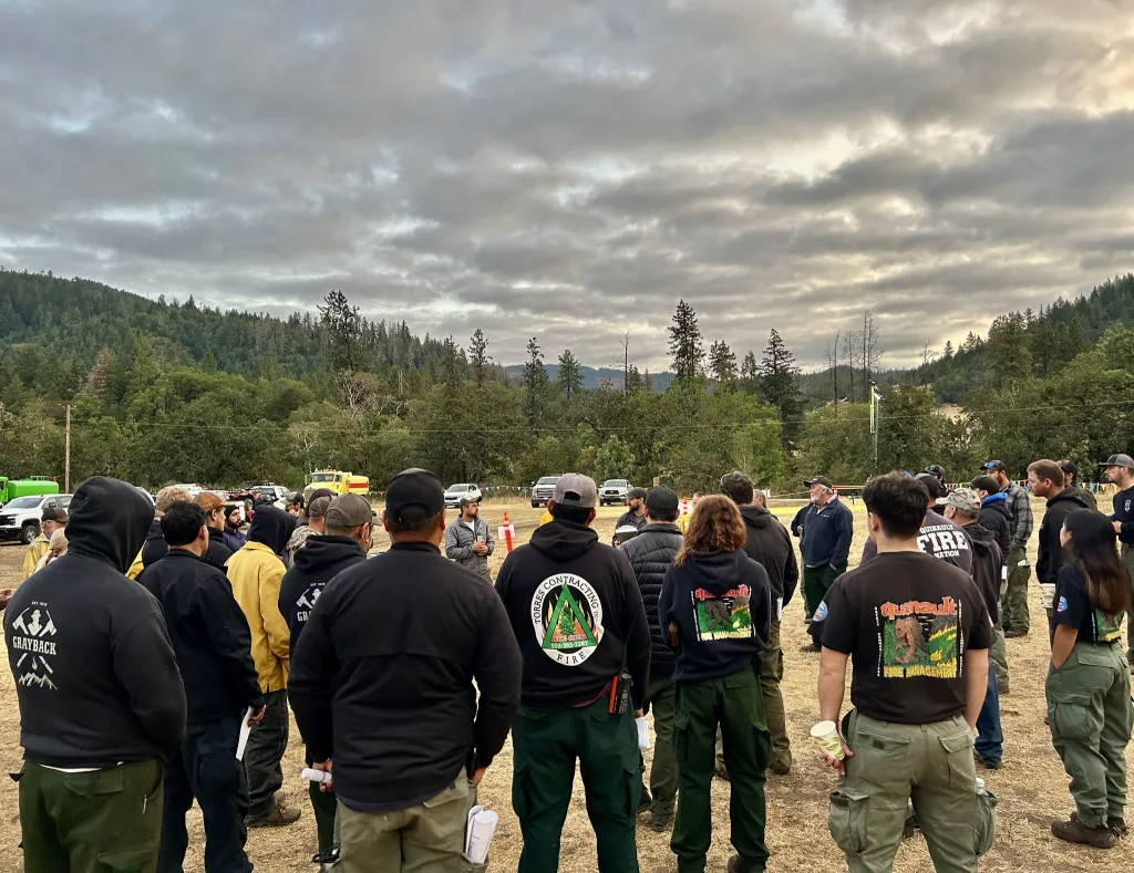 A crew getting a briefing on the Dixon Fire