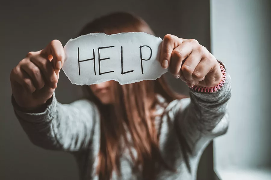 girl-holding-help-sign