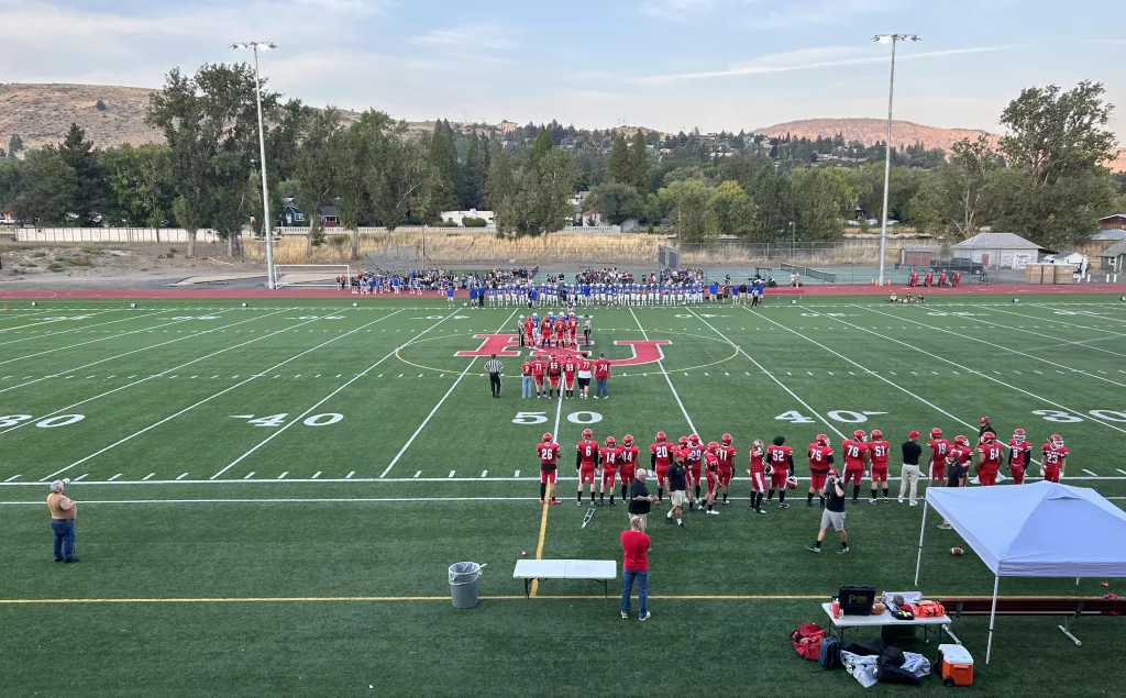 Klamath Union and Mazama captains meet at midfield before the Canal Bowl