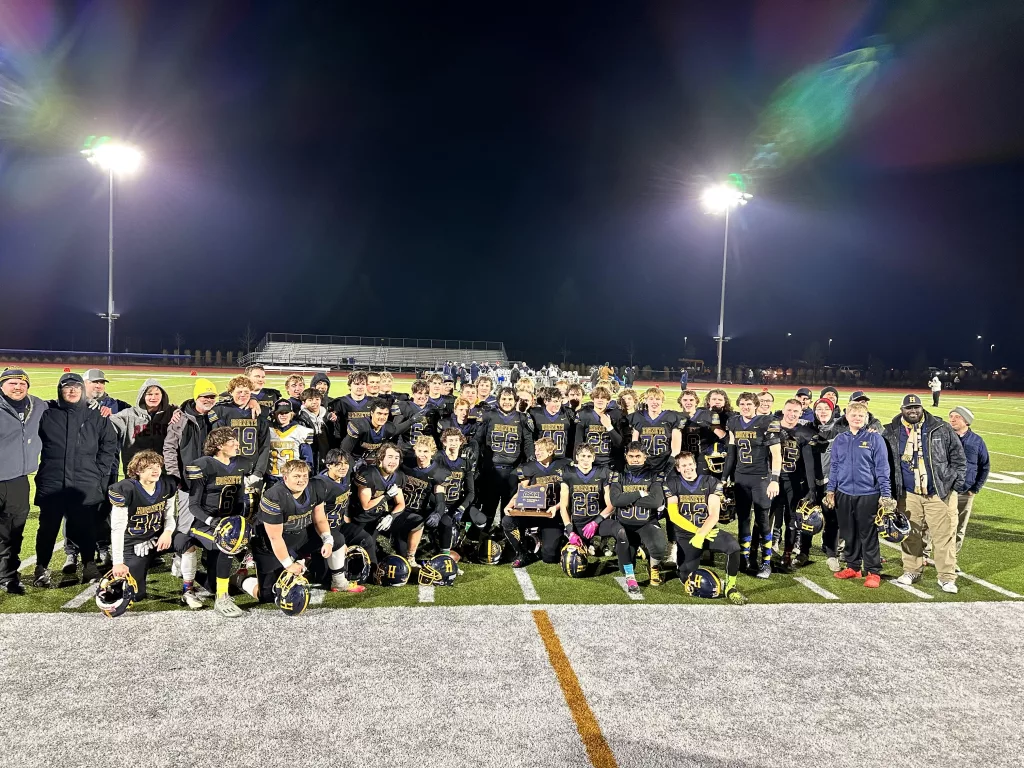 Henley football with the 2023 4A championship trophy