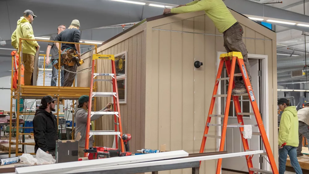 Students in the Klamath Community College Apprenticeship and carpentry program work on a small cottage that will be used to house displaced people from recent wildfires outside of Chiloquin last summer