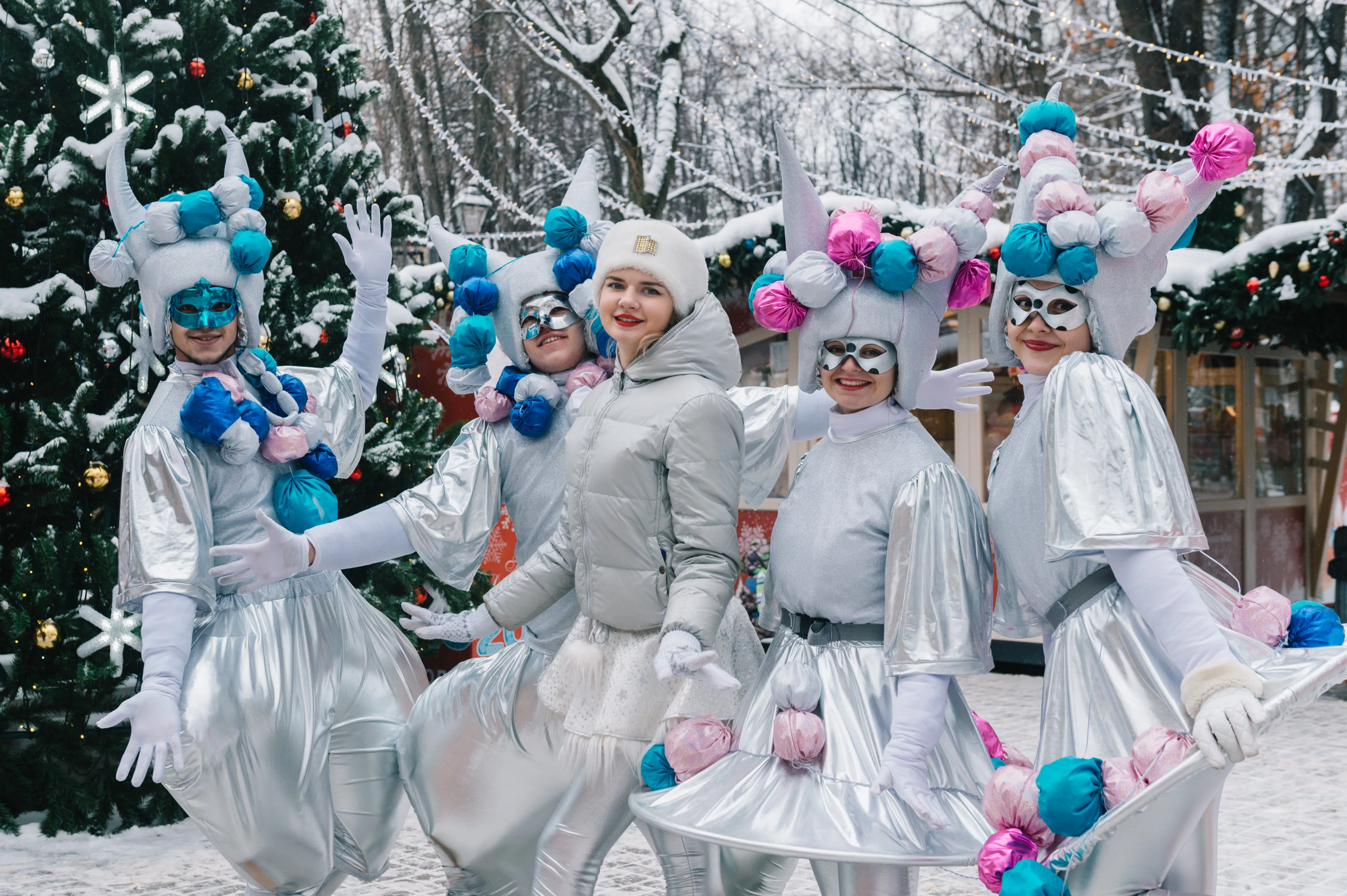 Girls in holiday costumes standing in snow