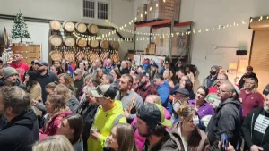 Hank's Holiday Treasure Party with people gathered inside a brewery