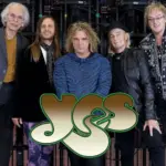 Yes, the BAND in front of a balck curtain with stage equipment surrounding them