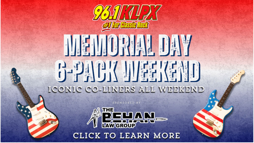 Promotional banner for 96.1 KLPX’s Memorial Day 6-Pack Weekend. Features the KLPX logo with the tagline '#1 For Classic Rock' at the top. Bold distressed text reads 'Memorial Day 6-Pack Weekend – Iconic Co-Liners All Weekend'. Two electric guitars with American flag designs flank the text. Sponsored by The Behan Law Group. A call-to-action at the bottom says 'Click to Learn More'. Red, white, and blue gradient background evokes a patriotic theme