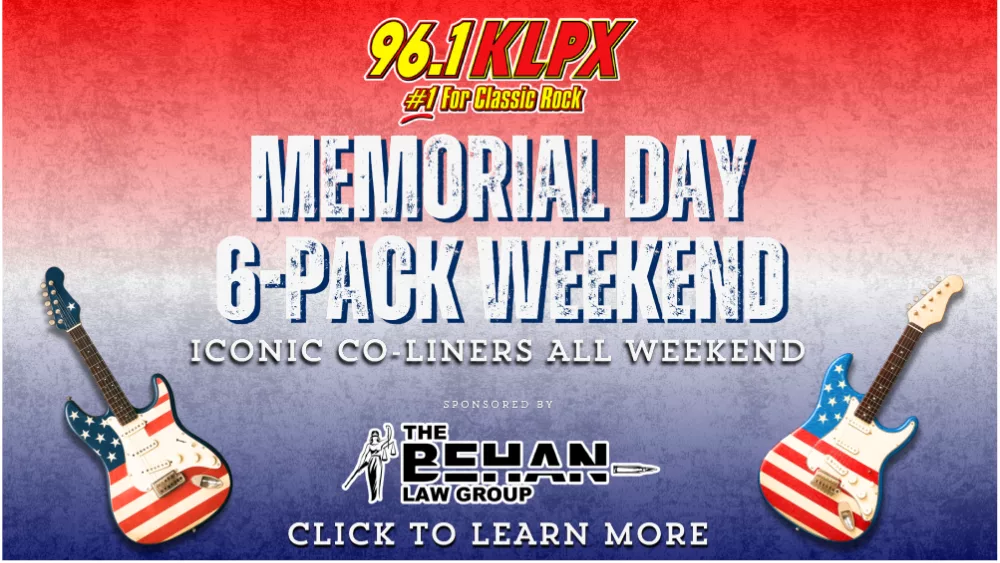 Promotional banner for 96.1 KLPX’s Memorial Day 6-Pack Weekend. Features the KLPX logo with the tagline '#1 For Classic Rock' at the top. Bold distressed text reads 'Memorial Day 6-Pack Weekend – Iconic Co-Liners All Weekend'. Two electric guitars with American flag designs flank the text. Sponsored by The Behan Law Group. A call-to-action at the bottom says 'Click to Learn More'. Red, white, and blue gradient background evokes a patriotic theme