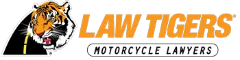 Law Tigers logo featuring a fierce tiger head over a curved yellow road, with bold orange text reading "LAW TIGERS" and the tagline "Motorcycle Lawyers" below — trusted motorcycle accident attorneys for riders across the U.S.