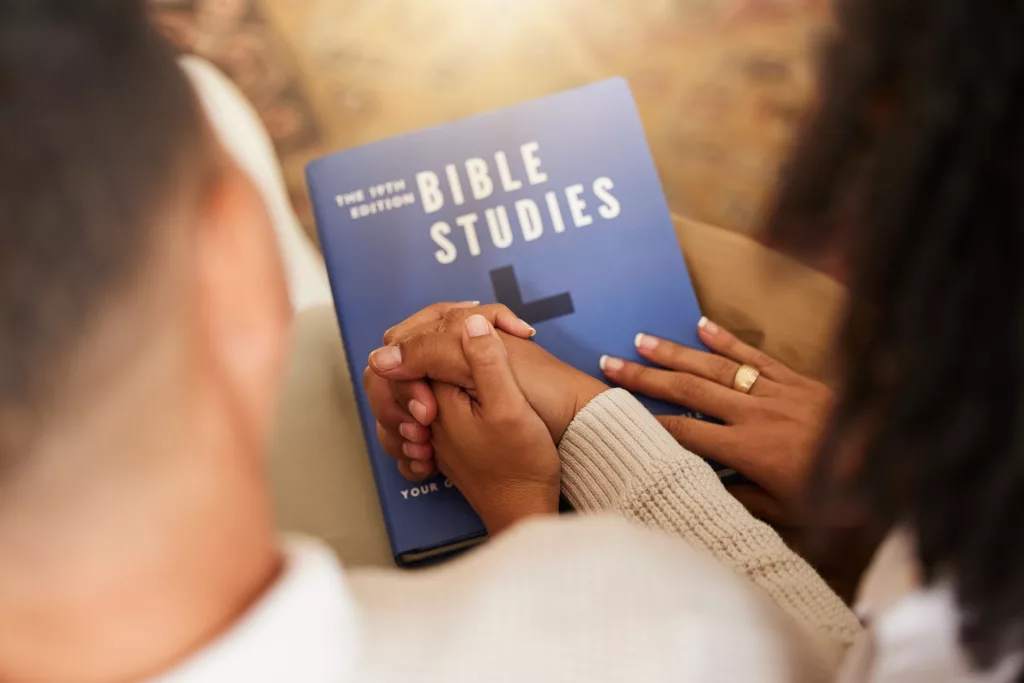 religion-studying-and-couple-holding-hands-with-a-2023-11-27-05-21-34-utc