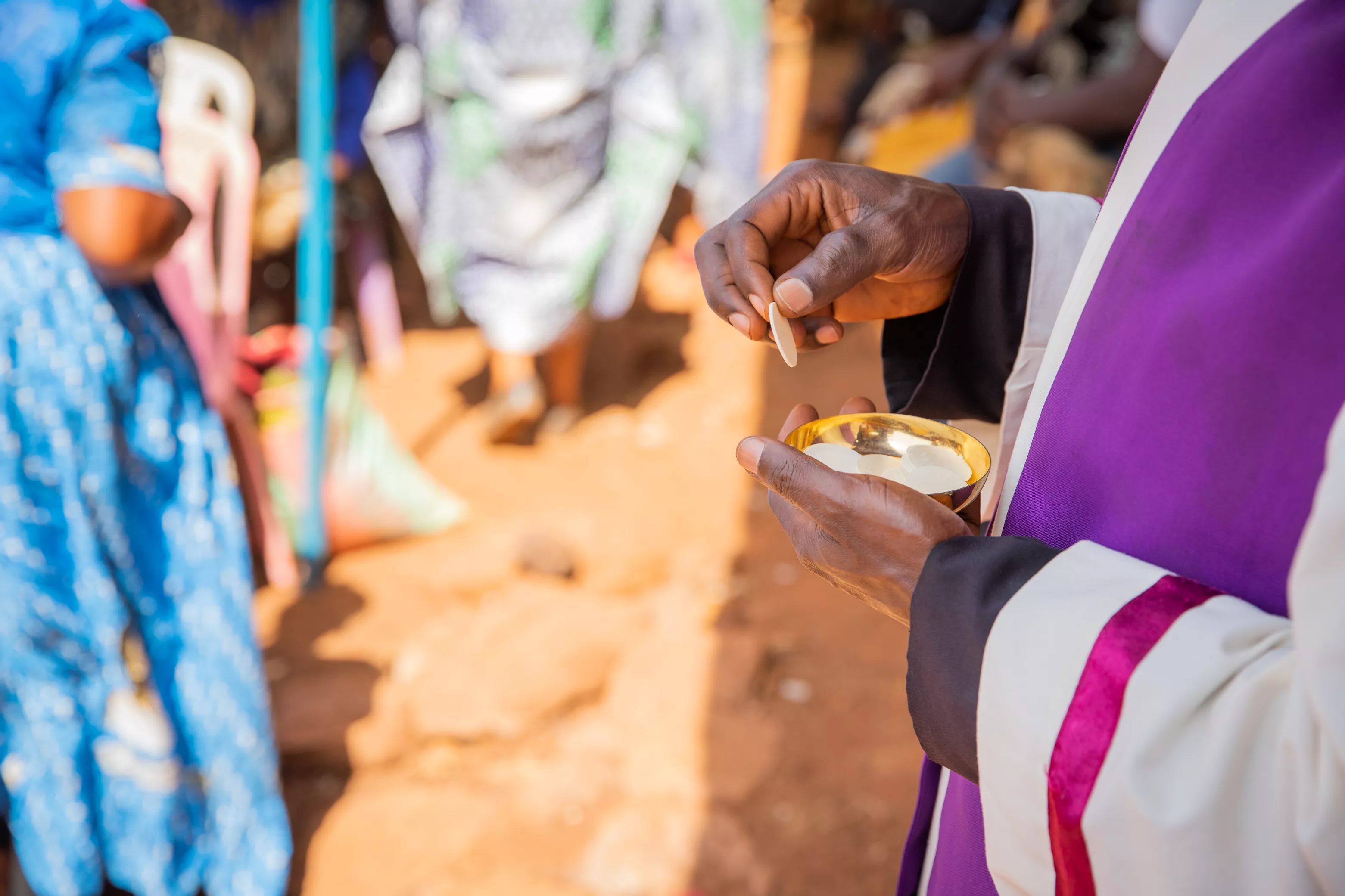 close-up-of-the-hands-of-an-african-priest-who-is-about-to-give-the-sacramental-bread-to-believers