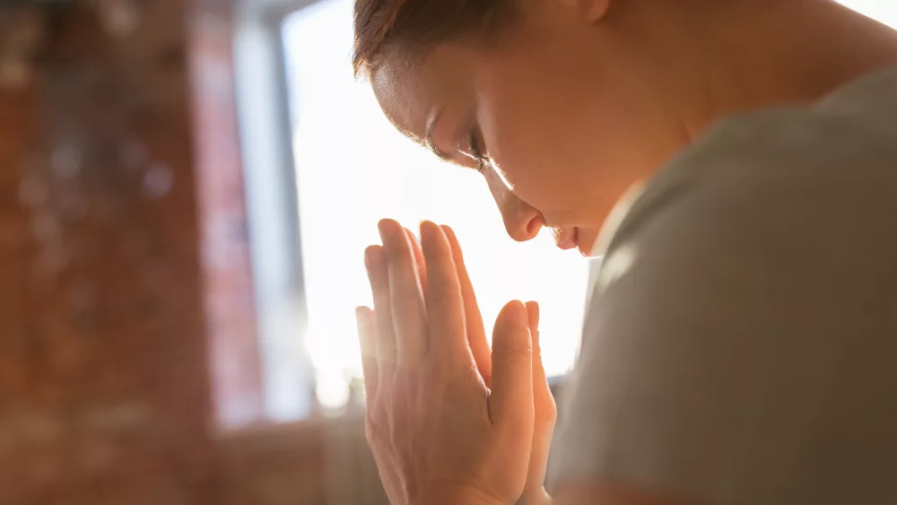 close-up-of-woman-meditating-at-yoga-studio