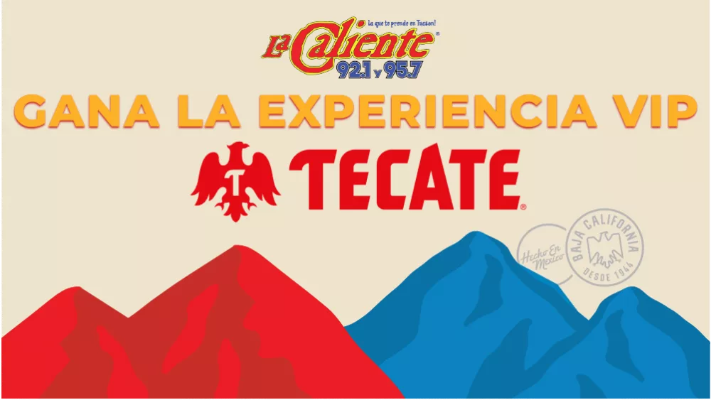 Promotional graphic with bold orange text reading “GANA LA EXPERIENCIA VIP” above the red Tecate beer logo and eagle symbol. At the top is the “La Caliente 92.1 y 95.7” radio station logo. The background features red and blue stylized mountain shapes with stamps reading “Hecho en México” and “Baja California Desde 1944