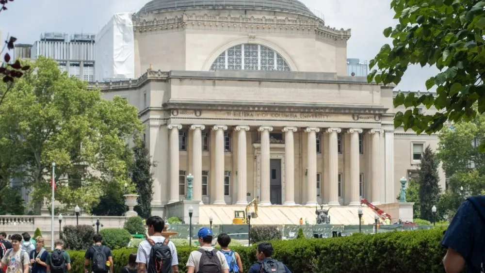 Students at the Columbia University campus on the Upper West Side of Manhattan. Steps of the Low Memorial Library in the background. New York^ NY^ USA - July 8^ 2022: