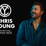 Chris Young with a goofy smile looking up into the sky