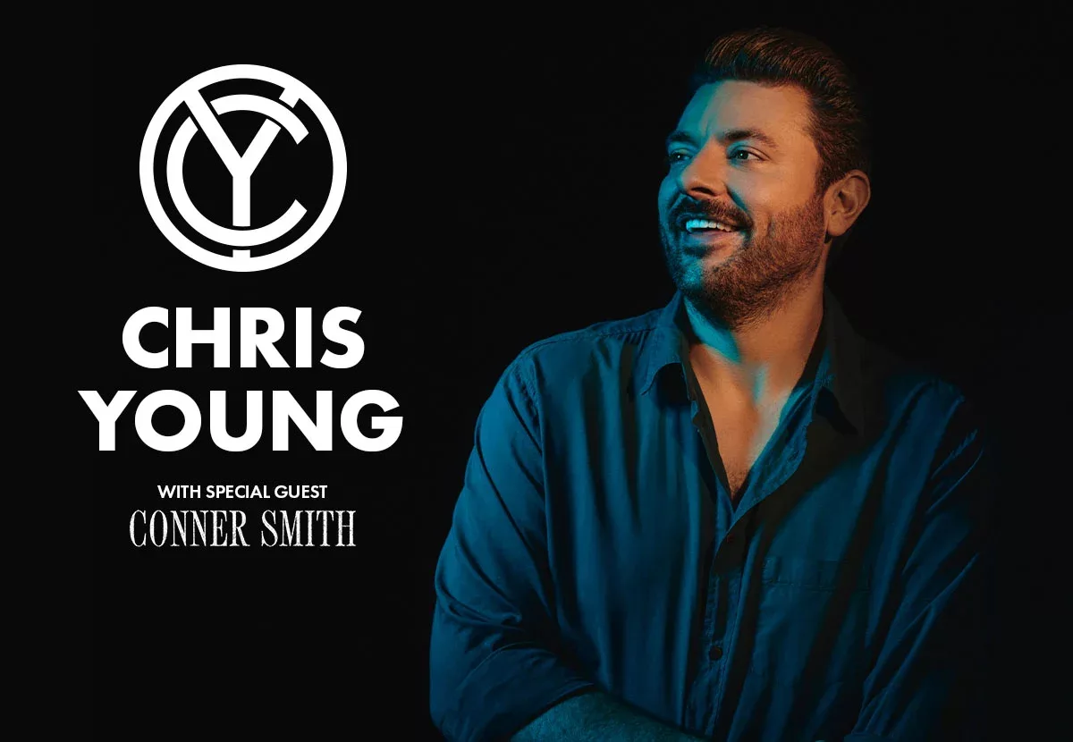 Chris Young with a goofy smile looking up into the sky