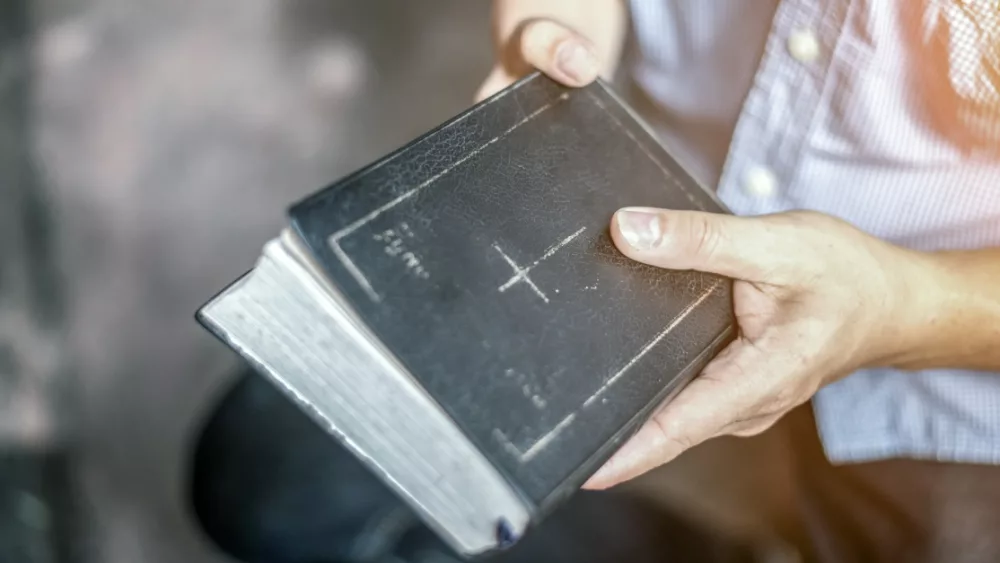 19958-man-holding-bible-gettyimages-boonchai-wedmak127836