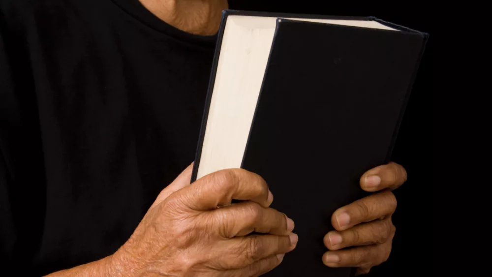 22794-woman-holding-bible-gettyimages-paulmaguire589140