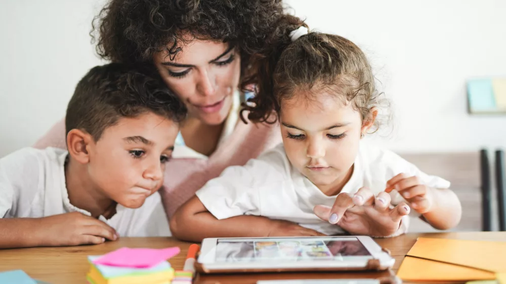 mother-doing-home-schooling-with-little-children-technology-an