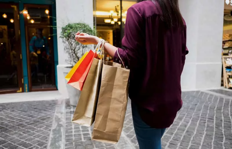 woman-holding-shopping-bag-while-walking-on-vintage-street-shop-5