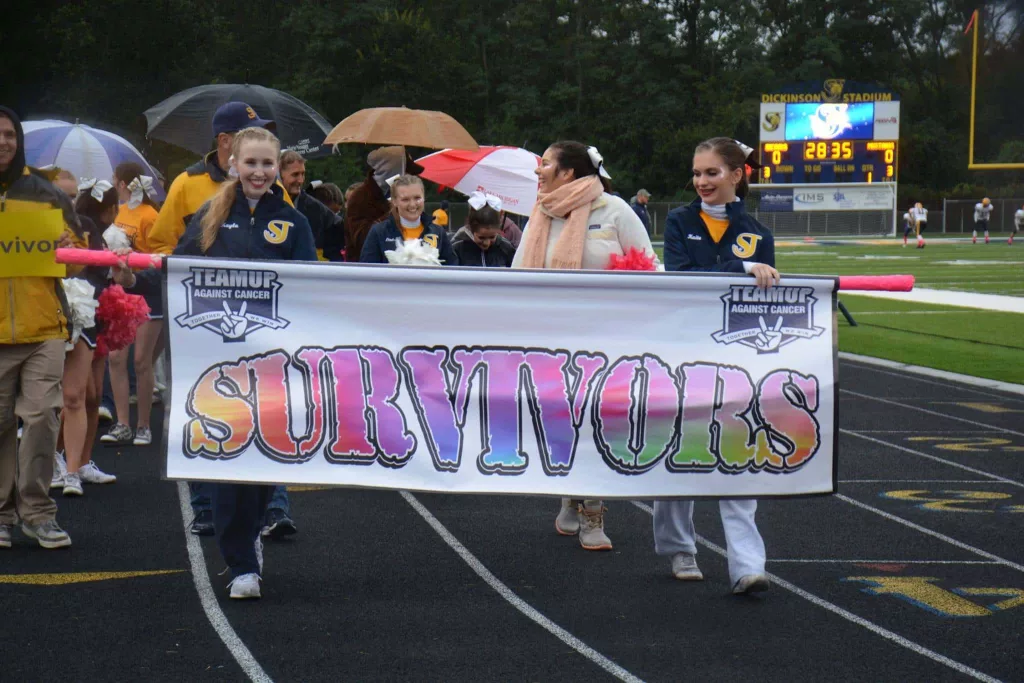 survivor-walk-into-stadium-w-cheerleaders
