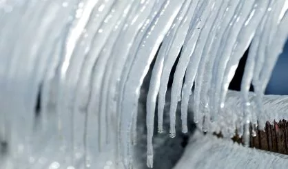 group-of-icicles-on-the-pier-in-winter