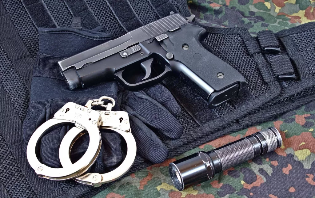 handgun-with-handcuffs-gloves-and-flashlight-on-tactical-vest-a-4