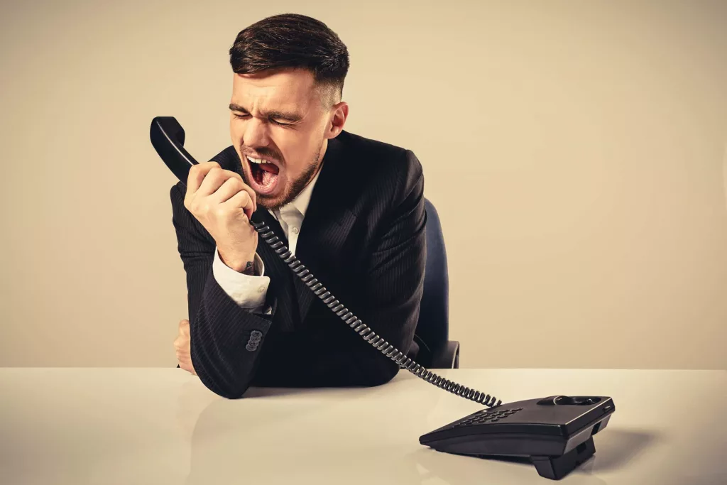 young-man-dials-the-phone-number-while-sitting-in-the-office-3