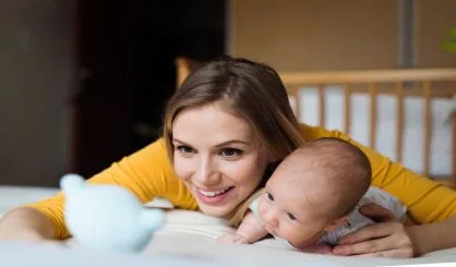 mother-with-her-newborn-baby-son-lying-on-bed-2